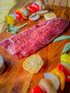 an Ostrich Steak Inside strip filet cut being prepared to be grilled.