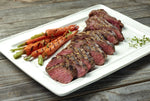 Delicious Ostrich Tenderloin Steak that's been grilled, seasoned and prepared next to carrots